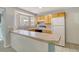 Bright kitchen with light wood cabinets, tile countertops, and white appliances at 115 Foxborough Rd, Goose Creek, SC 29445