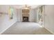 Bright living room with brick fireplace, ceiling fan, and sliding door to the backyard at 115 Foxborough Rd, Goose Creek, SC 29445