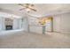 Open living area featuring fireplace, ceiling fan, and kitchen with tile floors and cabinets at 115 Foxborough Rd, Goose Creek, SC 29445