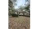 Wooden deck with surrounding trees and a glimpse of the house at 1291 Old Colony Rd, Mount Pleasant, SC 29464