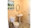 Bathroom with an oval mirror and a pedestal sink next to the toilet at 1291 Old Colony Rd, Mount Pleasant, SC 29464