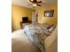 Cozy bedroom with a ceiling fan, a wooden desk, and a floral patterned bedspread at 1291 Old Colony Rd, Mount Pleasant, SC 29464