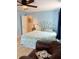 Tranquil bedroom features a ceiling fan, a bed with decorative headboard and a comfortable chair at 1291 Old Colony Rd, Mount Pleasant, SC 29464