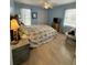 Serene bedroom with a ceiling fan, large windows, and a floral patterned bedspread at 1291 Old Colony Rd, Mount Pleasant, SC 29464