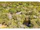 Gorgeous aerial view of a cozy home surrounded by green foliage and a shimmering pond at 1330 Sea Elder Dr # C, Kiawah Island, SC 29455