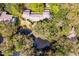 Aerial view of property surrounded by lush trees and a pond with a bridge at 1330 Sea Elder Dr # C, Kiawah Island, SC 29455