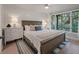 Bright bedroom with shiplap walls, large windows with natural light, and a comfortable bed at 1330 Sea Elder Dr # C, Kiawah Island, SC 29455