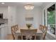 Dining room with a modern chandelier, view of trees, and seating for six guests at 1330 Sea Elder Dr # C, Kiawah Island, SC 29455