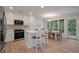 Contemporary kitchen features stainless appliances, white cabinets, and a breakfast bar overlooking the dining area at 1330 Sea Elder Dr # C, Kiawah Island, SC 29455