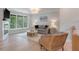 Bright living room features a fireplace, comfortable seating, hardwood floors, and backyard views at 1330 Sea Elder Dr # C, Kiawah Island, SC 29455
