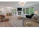 Cozy living room features a fireplace, natural light, hardwood floors, and an open floor plan to the kitchen and dining room at 1330 Sea Elder Dr # C, Kiawah Island, SC 29455