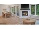Bright living room with a fireplace, TV, dining area, and scenic backyard view at 1330 Sea Elder Dr # C, Kiawah Island, SC 29455
