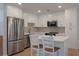 Contemporary kitchen featuring white cabinets, stainless steel appliances, and a kitchen island with seating at 1330 Sea Elder Dr # E, Kiawah Island, SC 29455