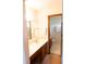 Bathroom featuring a double sink vanity and a view into an adjacent tiled shower area at 1438 Arrow Wind Ter, Charleston, SC 29414