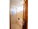 Bathroom featuring a shower with a bathtub and tiled surround, as well as towel racks and floral wallpaper at 1438 Arrow Wind Ter, Charleston, SC 29414