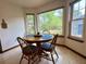 Bright breakfast nook with round table and views of the lush backyard at 1438 Arrow Wind Ter, Charleston, SC 29414
