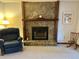 Living room featuring a stone fireplace, comfortable armchair, and cozy ambiance at 1438 Arrow Wind Ter, Charleston, SC 29414