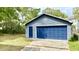 Detached garage with a large blue door and matching side door at 1438 Arrow Wind Ter, Charleston, SC 29414