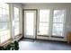 Bright sunroom featuring large windows, a door to the outside, and a calming, neutral color palette at 1438 Arrow Wind Ter, Charleston, SC 29414