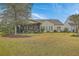 Expansive backyard featuring mature trees, a screened porch, and ample green space at 145 Billowing Sails St, Summerville, SC 29486