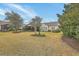 Well-maintained backyard with mature trees and landscaping providing a serene outdoor space at 145 Billowing Sails St, Summerville, SC 29486