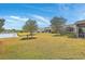 Enjoy serene views from this backyard featuring lush greenery and a tranquil pond at 145 Billowing Sails St, Summerville, SC 29486