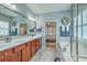 Bright bathroom with dual sinks, granite countertops, walk-in shower, and a separate soaking tub at 145 Billowing Sails St, Summerville, SC 29486