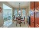 Charming dining area with a round table, elegant lighting, and access to bright sunroom at 145 Billowing Sails St, Summerville, SC 29486
