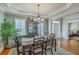 Open dining room features an elegant light fixture, a black hutch and access to the living room at 145 Billowing Sails St, Summerville, SC 29486