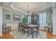 Elegant dining room features tray ceilings, wainscoting, and stylish chandelier with seating for six at 145 Billowing Sails St, Summerville, SC 29486