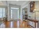 Spacious foyer with gleaming hardwood floors, elegant trim, and abundant natural light at 145 Billowing Sails St, Summerville, SC 29486