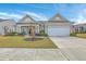 Charming single-story home with manicured lawn, tidy landscaping, covered porch, and attached two-car garage at 145 Billowing Sails St, Summerville, SC 29486