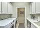 Modern laundry room with LG washer and dryer, white cabinets, and utility sink at 145 Billowing Sails St, Summerville, SC 29486