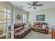 Cozy room with plush couches, decorative ceiling fan and access through french doors at 145 Billowing Sails St, Summerville, SC 29486