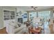 Cozy living room with built-in shelving, fireplace, and open floor plan leading to a sunroom at 145 Billowing Sails St, Summerville, SC 29486