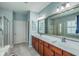 Main bathroom with and sinks, marble countertops, and a large mirror at 145 Billowing Sails St, Summerville, SC 29486