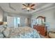 Comfortable main bedroom with trey ceiling, plantation shutters, and dark wood furniture at 145 Billowing Sails St, Summerville, SC 29486