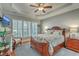 Comfortable main bedroom with trey ceiling, plantation shutters, and dark wood furniture at 145 Billowing Sails St, Summerville, SC 29486