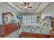 Comfortable main bedroom with trey ceiling, plantation shutters, and dark wood furniture at 145 Billowing Sails St, Summerville, SC 29486