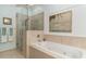 Bright bathroom with a luxurious soaking tub and a glass-enclosed shower, complemented by stylish fixtures at 1501 Sea Palms Cres, Mount Pleasant, SC 29464