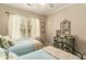 Charming bedroom with twin beds, vintage dresser, and neutral tones, creating a peaceful retreat at 1501 Sea Palms Cres, Mount Pleasant, SC 29464