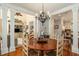 Charming dining room featuring a rustic wood table, chandelier, and views of the living room and kitchen at 1501 Sea Palms Cres, Mount Pleasant, SC 29464