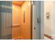Home elevator featuring wood paneling and gray metal accordion door at 1501 Sea Palms Cres, Mount Pleasant, SC 29464