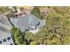 Aerial view of a gray home surrounded by lush trees with a view of the deck and rooftop at 1501 Sea Palms Cres, Mount Pleasant, SC 29464