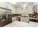 Bright kitchen with stainless steel refrigerator, white cabinets, and expansive countertop space at 1501 Sea Palms Cres, Mount Pleasant, SC 29464