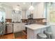 Charming kitchen features stainless steel appliances, granite countertops, and a breakfast bar at 1501 Sea Palms Cres, Mount Pleasant, SC 29464