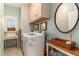 Functional laundry room with washer, dryer, storage cabinets, and a built-in desk area at 1501 Sea Palms Cres, Mount Pleasant, SC 29464