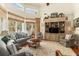 Bright living room with high ceilings, many windows, comfortable seating, and a stylish entertainment center at 1501 Sea Palms Cres, Mount Pleasant, SC 29464