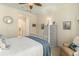 Comfortable bedroom features a white four-poster bed, cozy chair, and ample natural light at 1501 Sea Palms Cres, Mount Pleasant, SC 29464