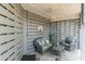Charming covered patio with comfortable wicker seating, a ceiling fan, and stylish decor at 1501 Sea Palms Cres, Mount Pleasant, SC 29464
